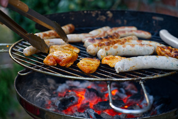 Grilled food on the grill with glowing charcoal