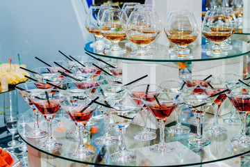 Brewery, drinks and alcohol concept, different types of beverages. Drinks in glasses on trolley ready to serve in a party.
