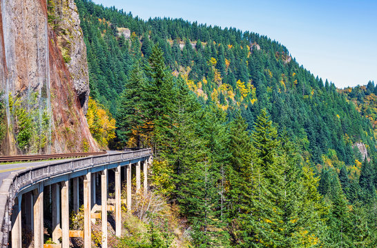 Bridge With A Road Around The Cliff On One Side And The Abyss Of The Other Side In The Forested Mountains In Columbia Gorge.