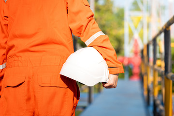 Oil field operator or worker is holding white safety hardhat, prepare to start the job on working...