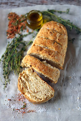Fresh homemade italian bread with olive oil and herbs. Selective focus. Macro