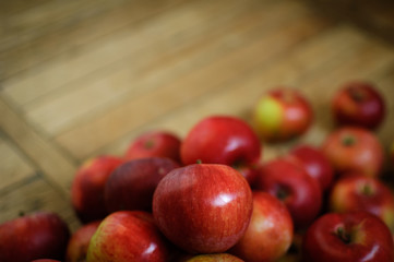 Close-up shot of ripe red juicy apples on wooden background, healthy eating concept, copy space