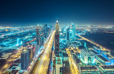 Downtown Dubai at night. Scenic aerial view on highways and skyscrapers.