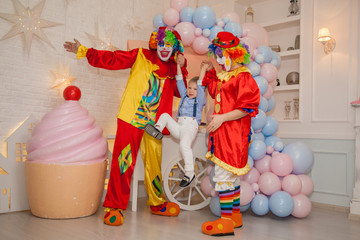 Circus clowns at the birthday party. Little boy and clowns. Party for children.