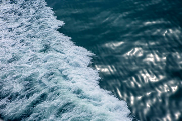 the waves from the ship on the background of the tranquil ocean