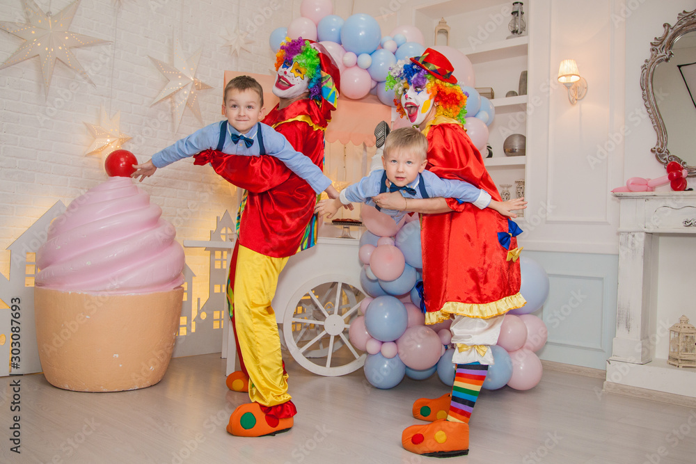 Wall mural Circus clowns at the birthday party. Boys and clowns. Party for children.