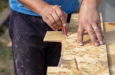 Worker measures the length of a construction site