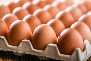 Egg. Fresh Chicken brown eggs in box.  Eggs on wood table.