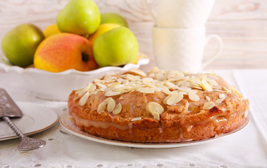 Apple pie with icing and almond topping