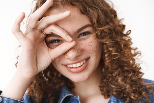 Headshot happy lucky positive young girl show okay ok sign around eye smiling joyfully having fun awesome day, standing positive expressing approval agree, optimistic mood standing white background