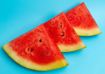 Ripe red watermelon isolated on a blue background