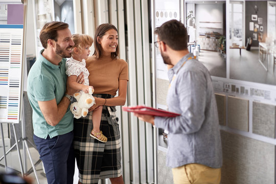 Family Man And Woman Choosing  Household In Furniture Store