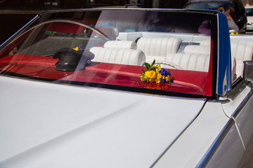 Fototapeta premium Antique white convertible decorated with yellow flowers.