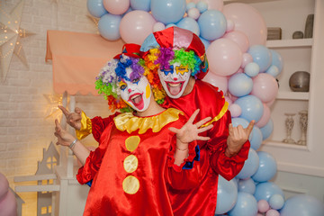 Funny clowns from the circus. Clown boy and clown girl show emotions