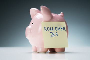 Rollover Ira Text On Note With Piggy Bank