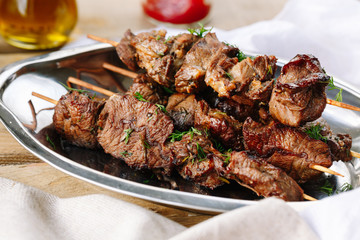 grilled meat and vegetables on plate isolated on white
