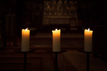 three candles on the black background