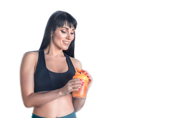 sporty young girl with orange water bottle isolated on white background