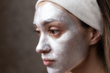 Young brunette with brown eyes in modeling face mask
