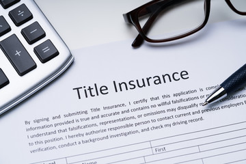 Title Insurance Form Over White Desk