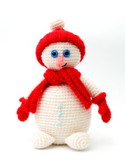 Knitted snowman toy on a white background close-up