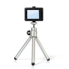 Action camera on mini tripod with white background.