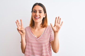 Beautiful redhead woman wearing casual striped red t-shirt over isolated background showing and pointing up with fingers number eight while smiling confident and happy.