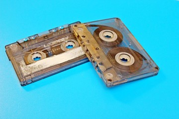 Transparent audio cassettes located on a blue background