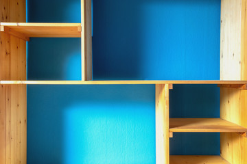 wooden storage shelves with blue wall background modern interior home