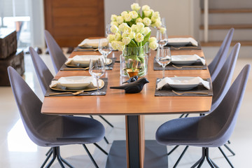 Wine glass luxury banquet dining table settings decoration serving with dishes, glass, napkins on wooden dining table interior contemporary concept