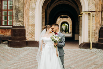 Amazing couple stands in a churchyard