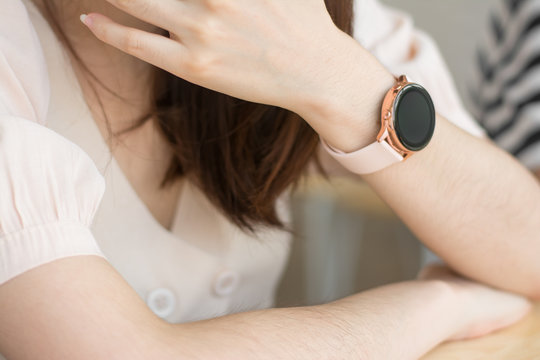 In hall station a woman using his smart watch app. business, technology and people concept - close up of woman hands setting smart watch.