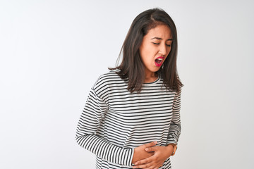 Young beautiful chinese woman wearing striped t-shirt standing over isolated white background with hand on stomach because indigestion, painful illness feeling unwell. Ache concept.