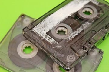 Old audio cassettes arranged on a green background