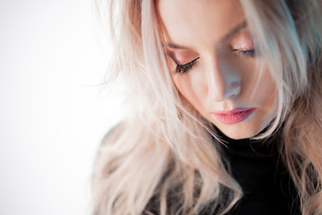 Charming blonde with sloppy curls, close-up