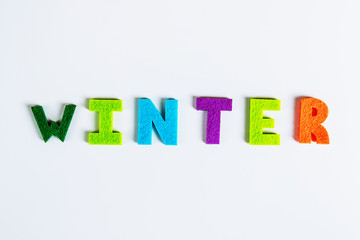 The word WINTER is written in multicolored letters. Winter time concept.