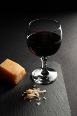 a glass of red wine with  parmesan cheese