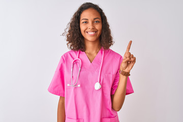 Young brazilian nurse woman wearing stethoscope standing over isolated white background showing and...