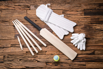 Fototapeta na wymiar Cricket Accessories And Tools On Textured Backdrop