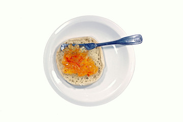 orange marmalade on muffin small white plate