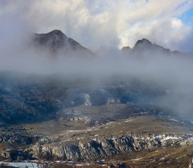 mountain valley  in a mist and dense clouds, outdoor travel background
