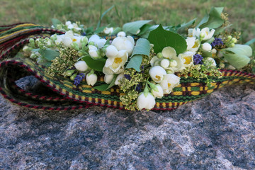 folk belt and flower crown, symbols of Latvian identity
