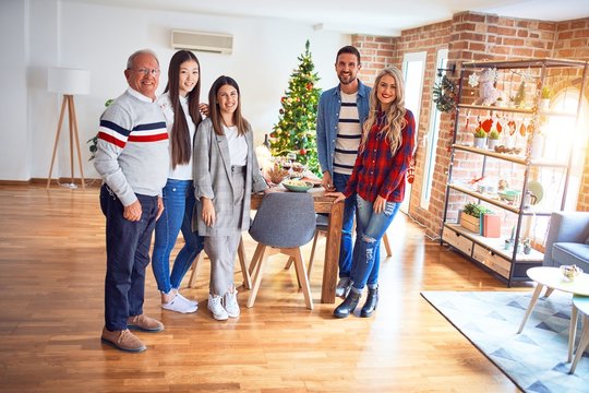 Beautiful family smiling happy and confident. Standing posing with tree celebrating Christmas at home