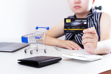 Close-up of young women using mobile phones and credit cards for online payments, Online shopping concept.