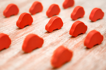 Set of red cars on wooden background. 3D printing concept. Car industry. Car insurance. Lot of toy...