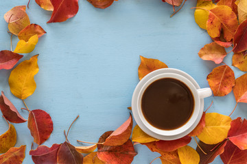 Fototapeta na wymiar Autumn lifestyle with coffee cup and fall leaves. Copy space.