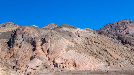 Interesting rock formations on Artist's drive in Death Valley National Park in California. Clear blue sky background