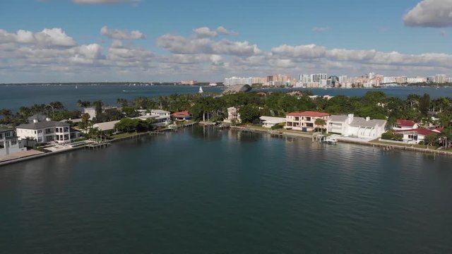 Sarasota, Florida.  Buttery smooth view of luxury island residences and downtown Sarasota located on the Gulf of Mexico.  Clip transitions to the causeway.  Perfect weather and lighting.