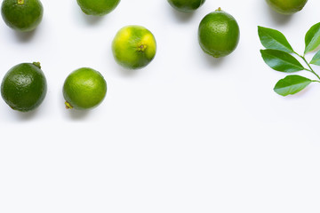 Fresh limes with leaves isolated on white