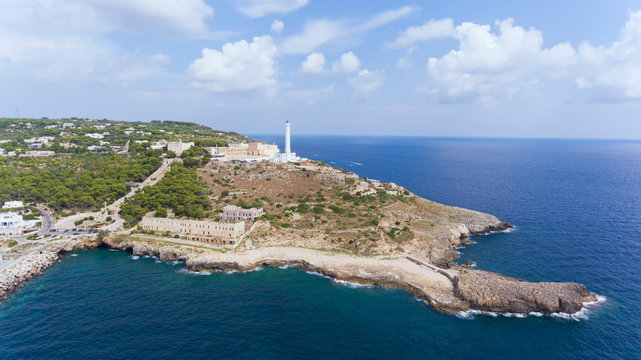 Aerial photo of White lighthouse of Santa Maria di Leuca on the hilltop, the southernmost point in Salento, overlooking two seas the Ionian and the Adriatic .
